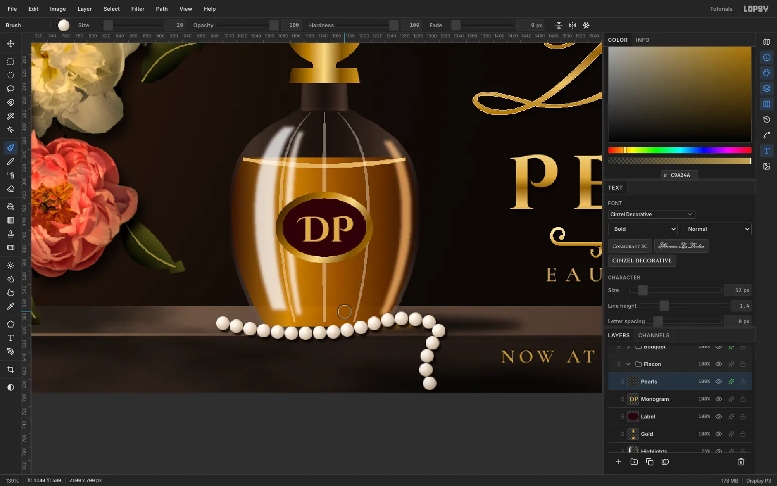 A strand of pearls lying across the ledge in front of the bottle in a loose curve, then rolling over the ledge lip and hanging down the front face