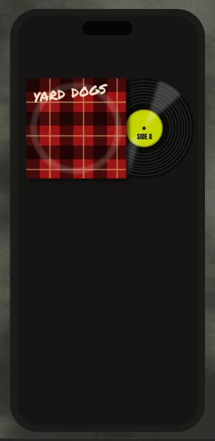 The dark phone's flannel sleeve with a black vinyl record peeking out from behind it on the right, showing fine grooves, a soft diagonal sheen and a chartreuse label reading SIDE A