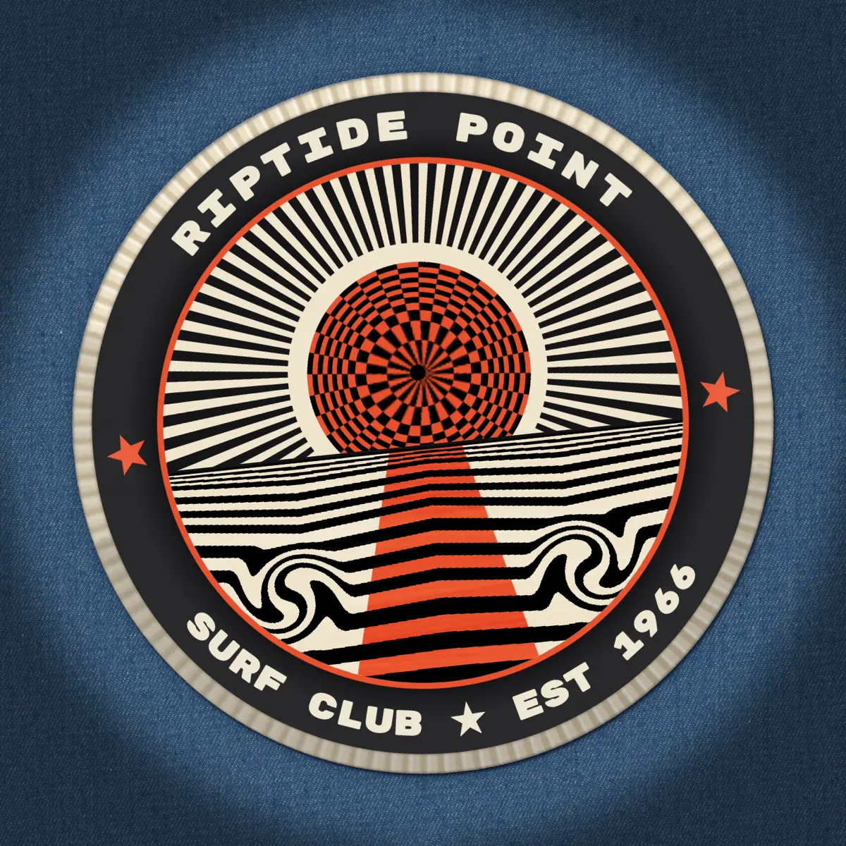 The finished Riptide Point Surf Club patch, ironed onto blue denim at a slight angle. A cream overlocked edge rings a black band lettered RIPTIDE POINT across the top and SURF CLUB ★ EST 1966 along the bottom, with a coral star at each side. Inside a thin coral keyline, black and cream rays radiate from a coral and black polar checkerboard sun that bulges like a sphere, with a black dot at its centre. Below a ruled horizon the sea is made of black and cream stripes that squeeze together toward the horizon, curl into two mirrored riptide eddies, and are cut by a coral reflection that widens toward the viewer